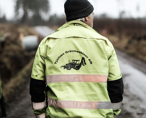 Industrial motor grader and backhoe excavator on highway constru